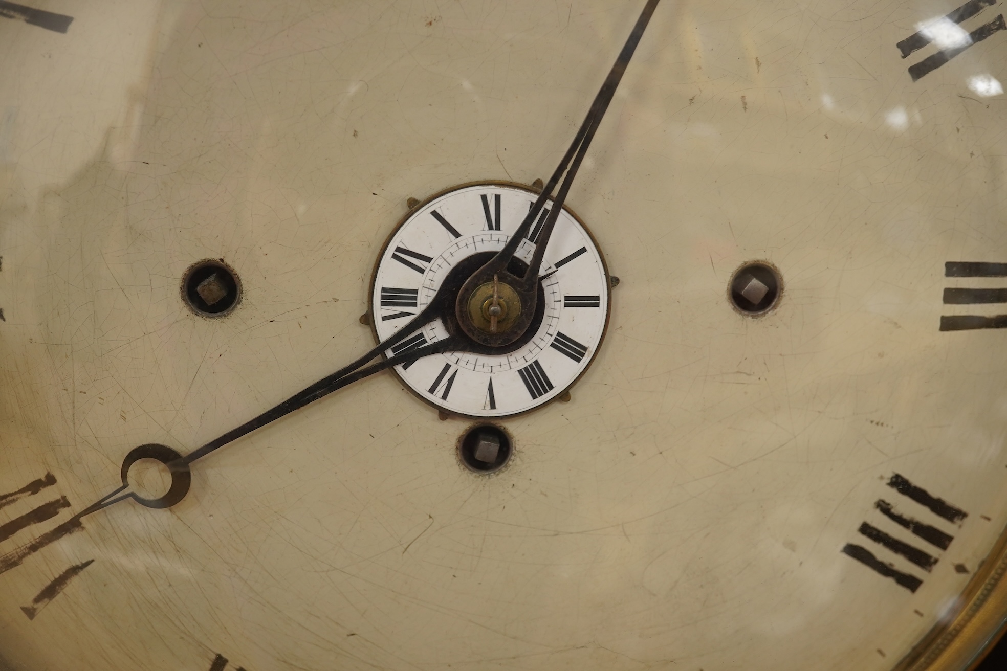 A Regency ebonised and brass inlaid lancet-shape bracket clock, with key and a painted pottery strut timepiece, largest 55cm high (2)